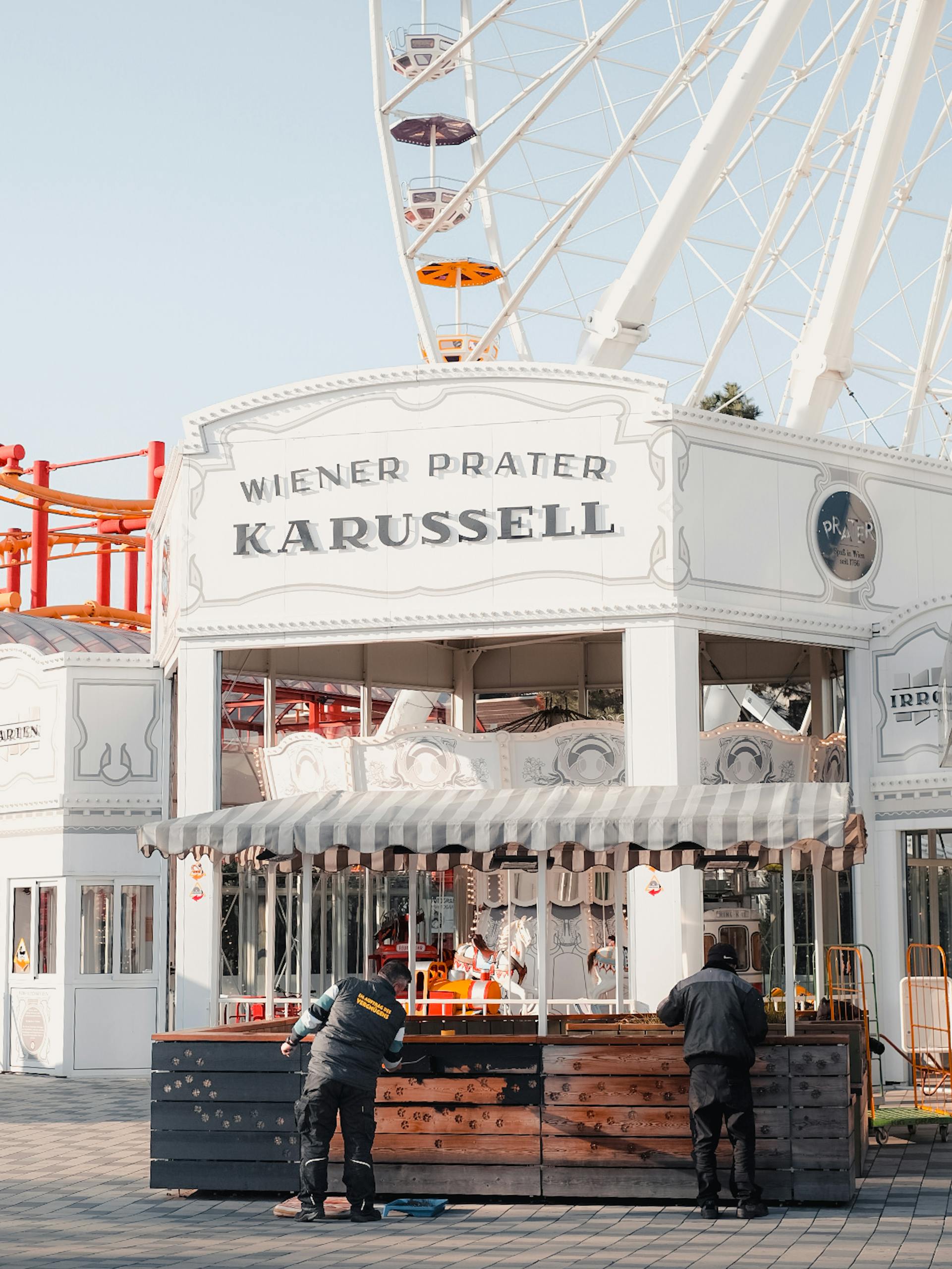 View of the iconic Wiener Prater carousel and Ferris wheel in Vienna, Austria.